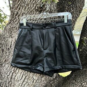Pair of black vinyl shorts